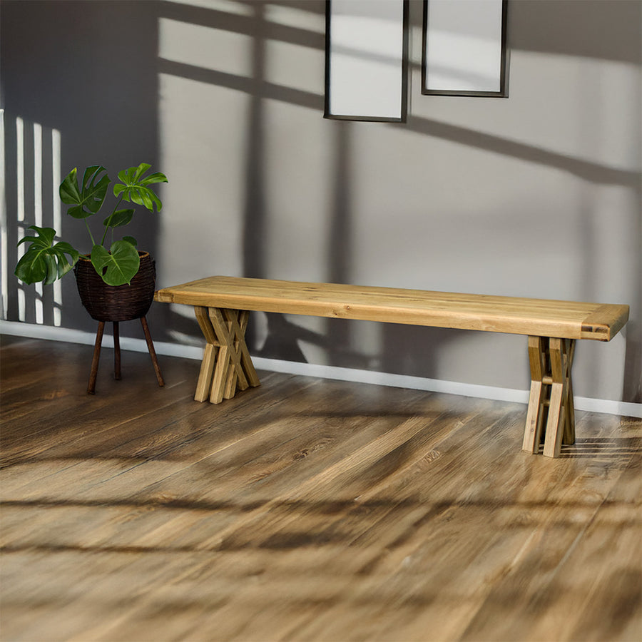 An overall view of the Arpege Oak Cross Leg 2m Bench Seat. There is a free standing potted plant next to it.