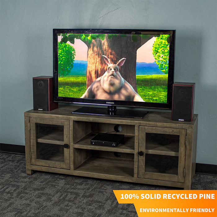 The front of the Stonemill Recycled Pine TV Unit with a TV and two speakers on top. There is a DVD player in the top shelf in the middle.