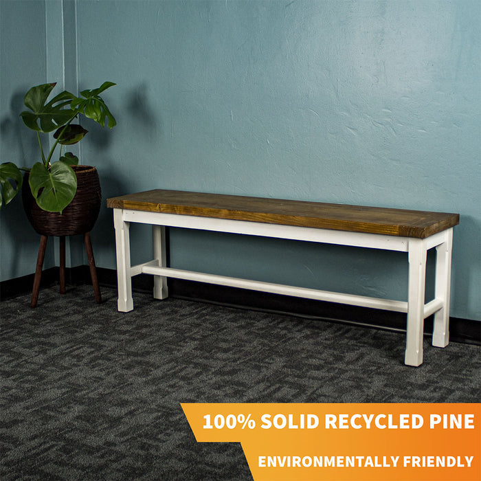 Front of the Tuscan Recycled Pine Bench. There is a free standing potted plant next to it.