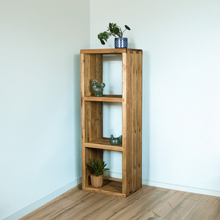 Front of the Vancouver Value Triple Cube. There is a potted plant on top, a blue glass ornament on the top shelf, a blue glass ornament on the middle shelf, and a potted plant on the bottom shelf.