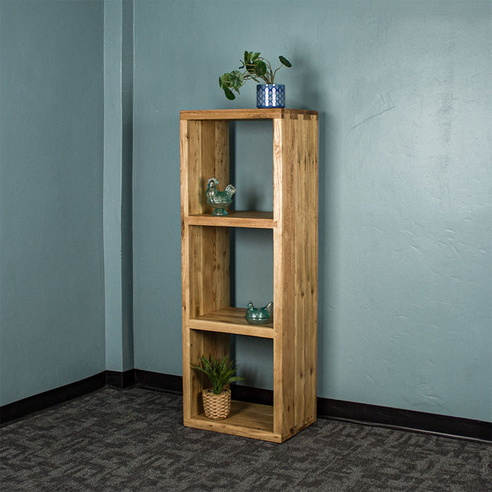 Front of the Vancouver Value Triple Cube. There is a potted plant on top, a blue glass ornament on the top shelf, a blue glass ornament on the middle shelf, and a potted plant on the bottom shelf.