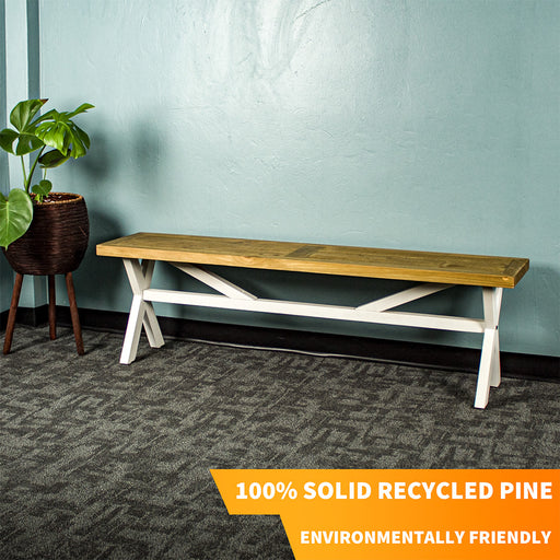 The white and rimu-stained top Byron Recycled Pine Bench with cross legs and a support bar through the middle.