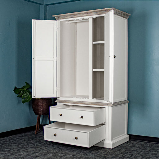 An overall view of the Biarritz Two-piece Wardrobe with its drawers and doors open. There is a free standing potted plant next to it.