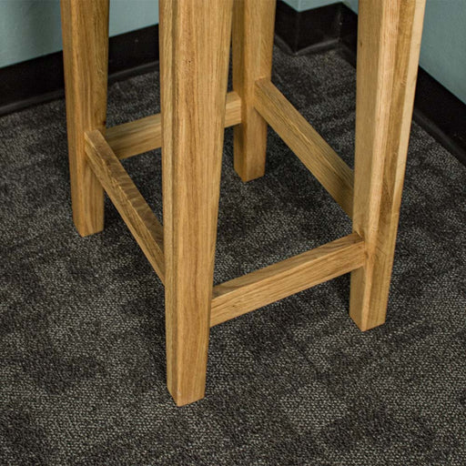 A close up of the lower side of the Vienna Oak Bar Stool.