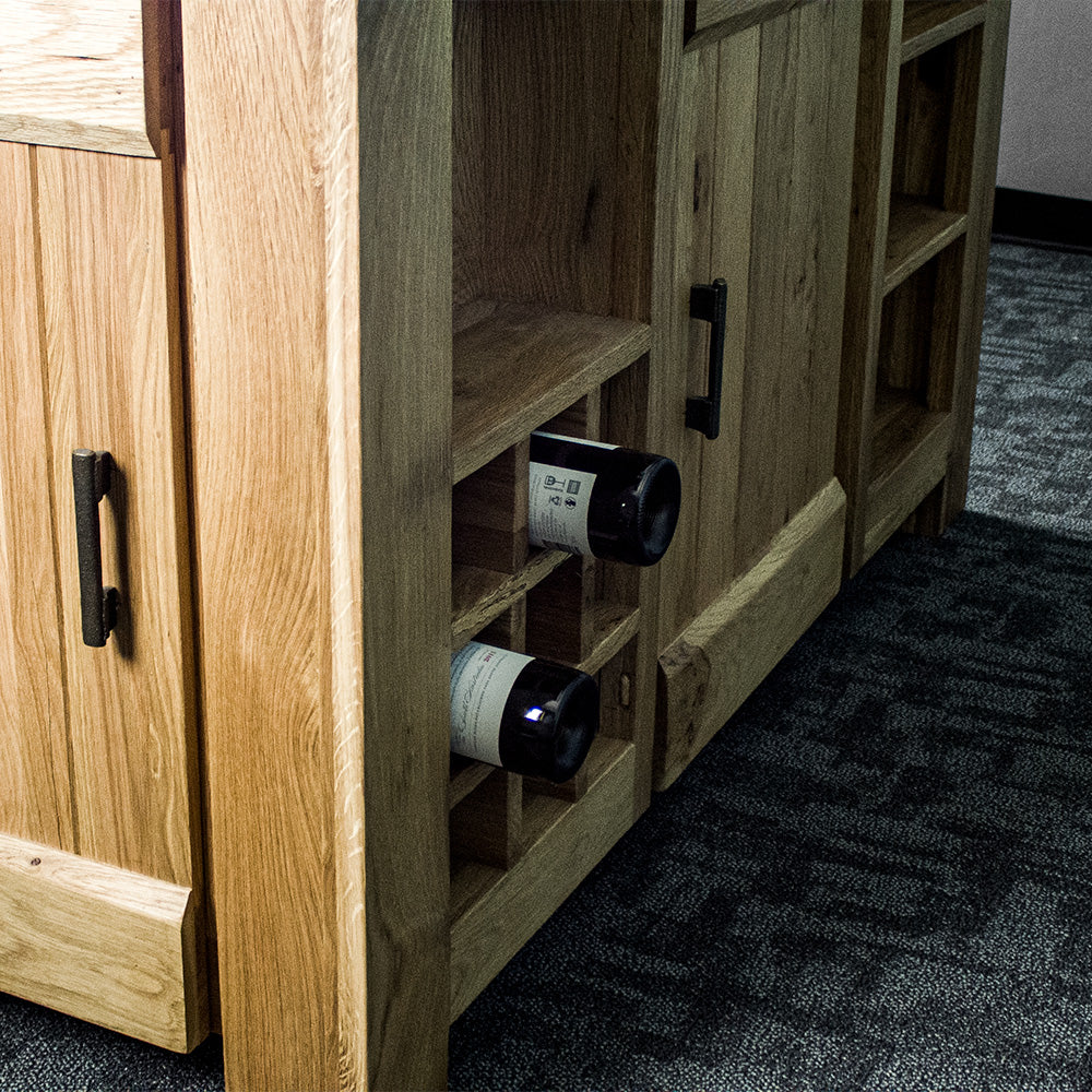 A view of the back of the Camden Granite Top Kitchen Workbench, showing the wine rack. There are two wine bottles sticking out of it.