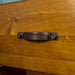 Close up of the leather and bolted metal handle on the drawers of the Jamaica 6 Drawer Pine Lowboy