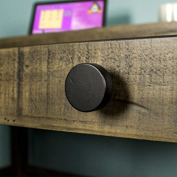 Close up of the black circular handle on the Stonemill Recycled Pine Desk