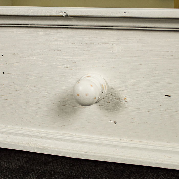 A close up of the doorknob style handle on the Tuscan Recycled Pine TV Unit.