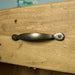 A close up of the black metal handle on the drawer of the Ventura Recycled Pine Buffet