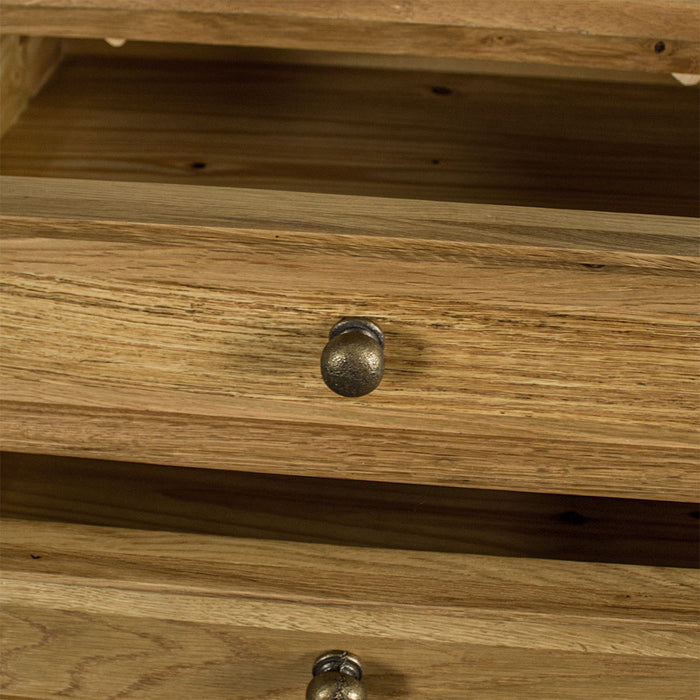 A close up of the brushed brassy coloured door knob style handles on the drawers and doors of the Versailles Large Oak Buffet