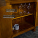 A closer view of the shelving inside the Montreal Compact Pine Buffet. There are three wine glasses on the top shelf and two coffee mugs on the lower shelf.
