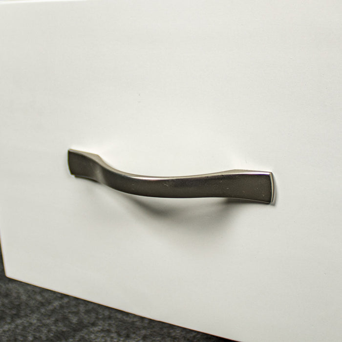 A close up of the silver coloured metal handle on the Felixstowe Pine Bedside Cabinet (White)