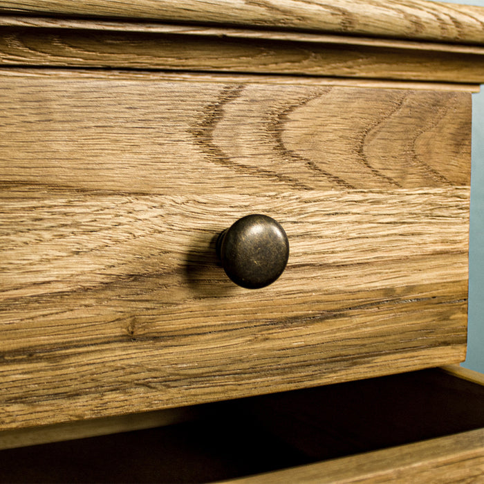 A close up of the metal handle on the Beethoven Oak Bedside Table with 3 Drawers.