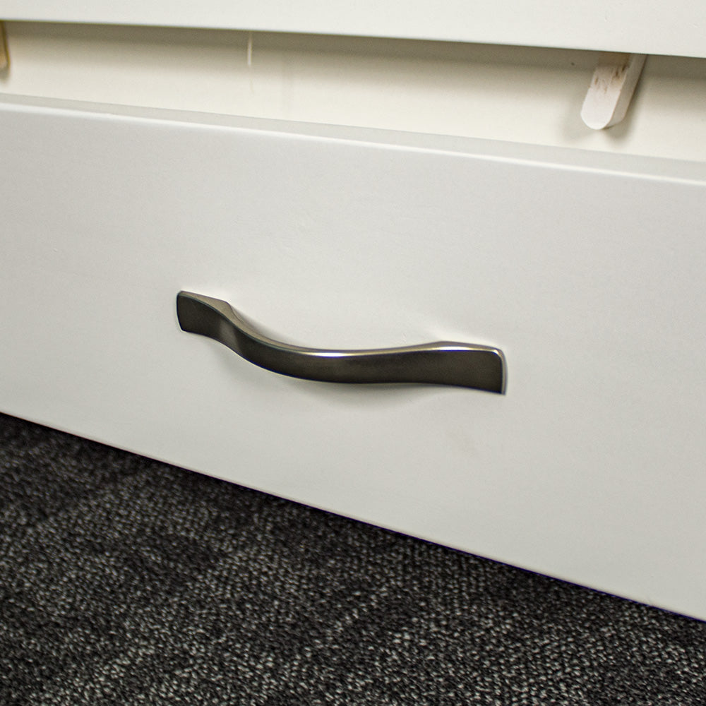 A close up of the silver metal handle on the Felixstowe Pine Bookcase.