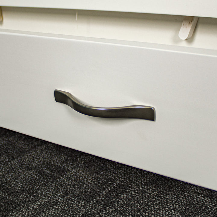 A close up of the silver metal handle on the Felixstowe Pine Bookcase.
