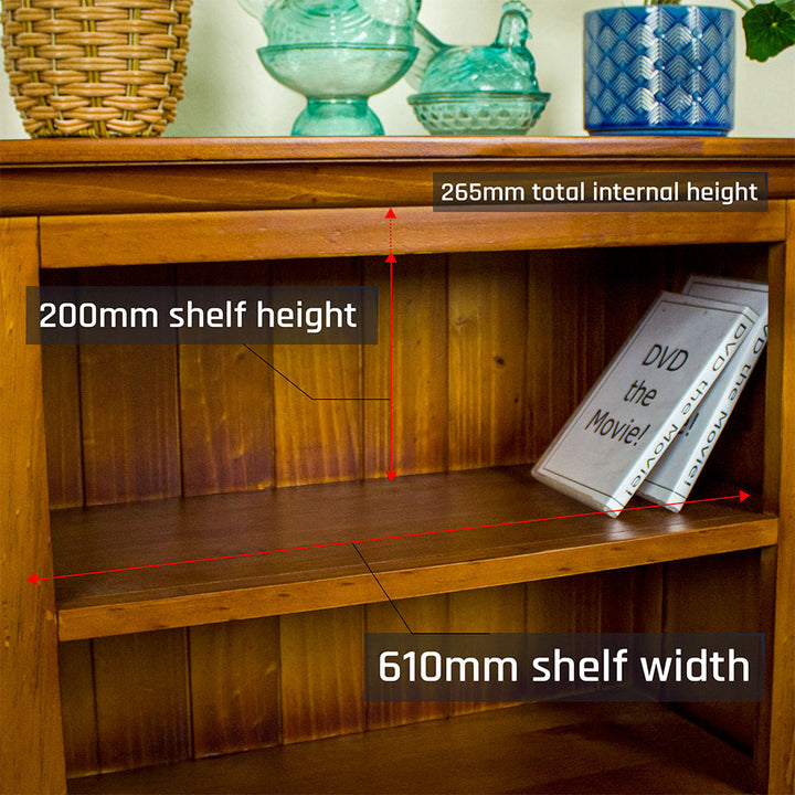 A closer view of the top shelf on the Montreal Low Pine Bookcase. There are two DVD cases on the shelf.