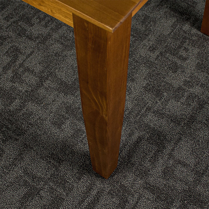 A close view of the leg of the Hamilton Rimu Stained Dining Table (1500mm)