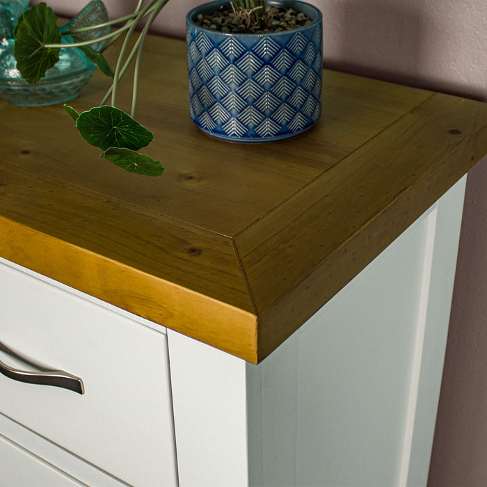 A close up of the top of the Felixstowe 5 Drawer Pine Tallboy, showing the wood grain and colour.
