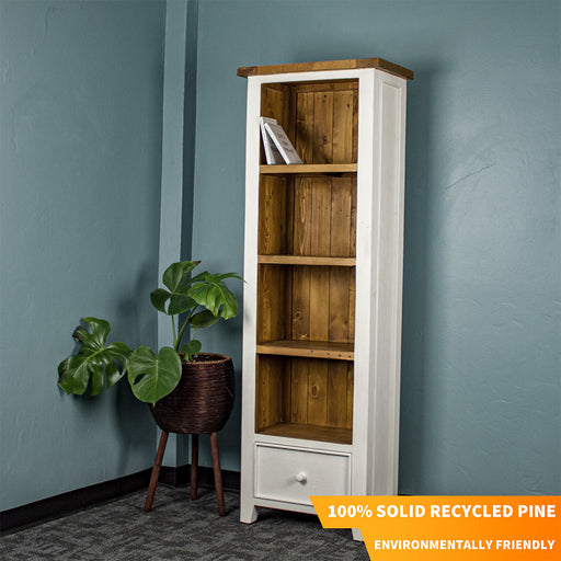 The Tuscan Recycled Pine Tall Bookcase, which as a white exterior and a pine-brown interior and shelving, as well as a brown top. There is text in the corner that says "100% Solid Recycled Pine" and "Environmentally Friendly".