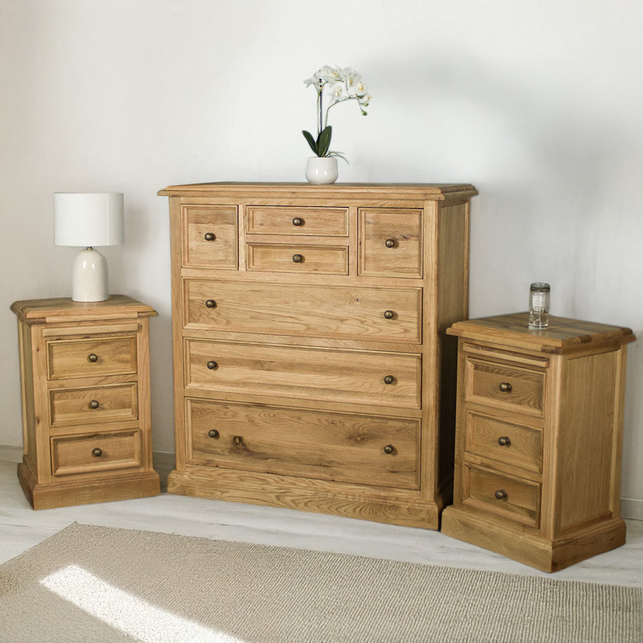 The Versailles 3 Piece Bedroom Suite. There are two Versailles Oak Bedside Cabinets on either side of the Versailles Oak 7 Drawer Chest.