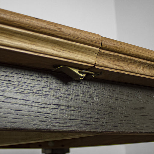 A close up of the clip that holds the Boston Oak Extending Dining Table together when not extended.