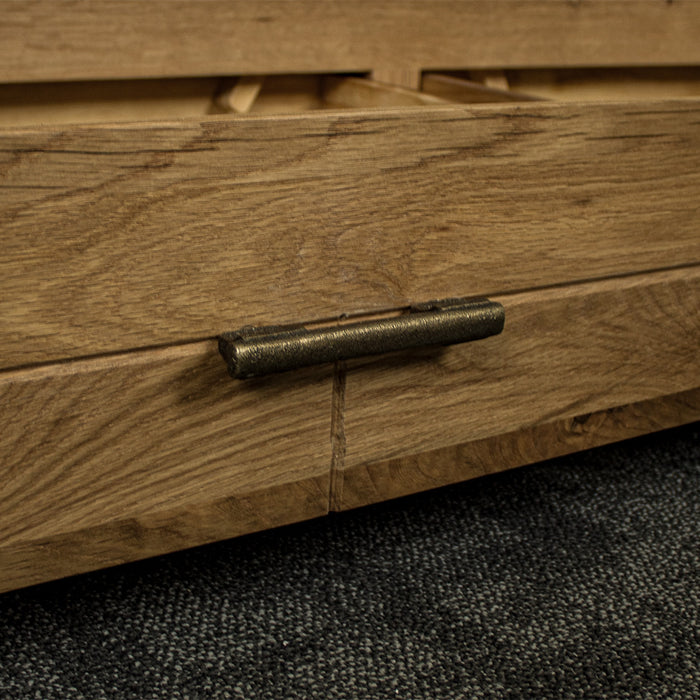 A close up of the brushed brass handle on the drawers of the Camden 2 Drawer White Oak Entertainment Unit.