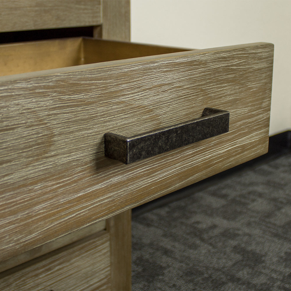 A close up of the brushed black metal handle on the drawers of the Vancouver 3 Drawer Bedside Cabinet.
