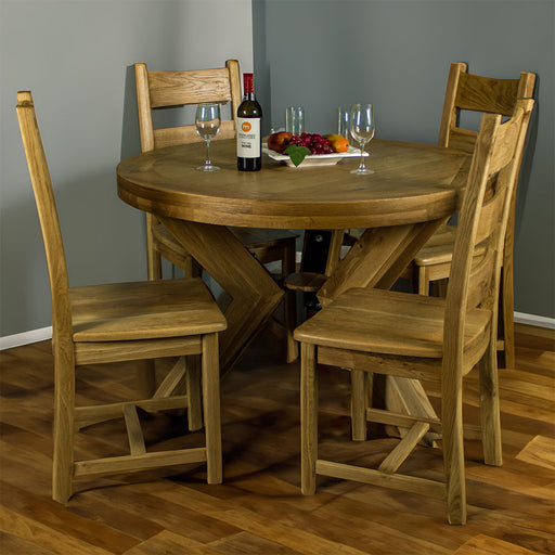 Overall view of the Amstel 5 Piece Oak Dining Suite with four glasses and a fruit platter on top, inside a dining room.