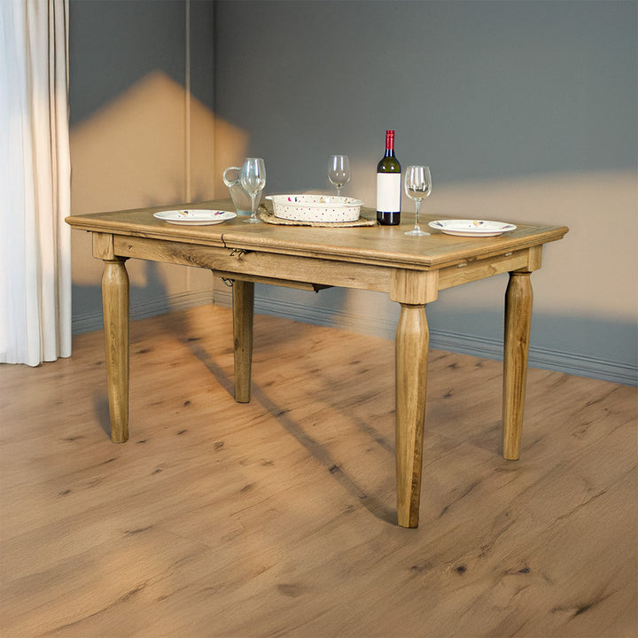 An overall view of the Boston Oak Extending Dining Table - Natural Oak, with kitchenware and plates on top. 