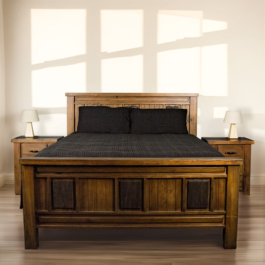 The front of the Botanica King Slat Bed Frame, dressed in duvets and pillows.