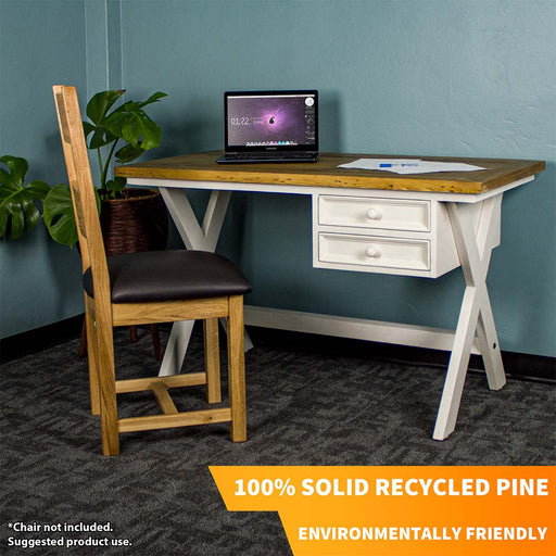 The front of the Byron Recycled Pine Desk. There is a laptop and a pile of papers on top of the desk. There is an upholstered oak chair in front of the desk and a free standing potted plant next to it.