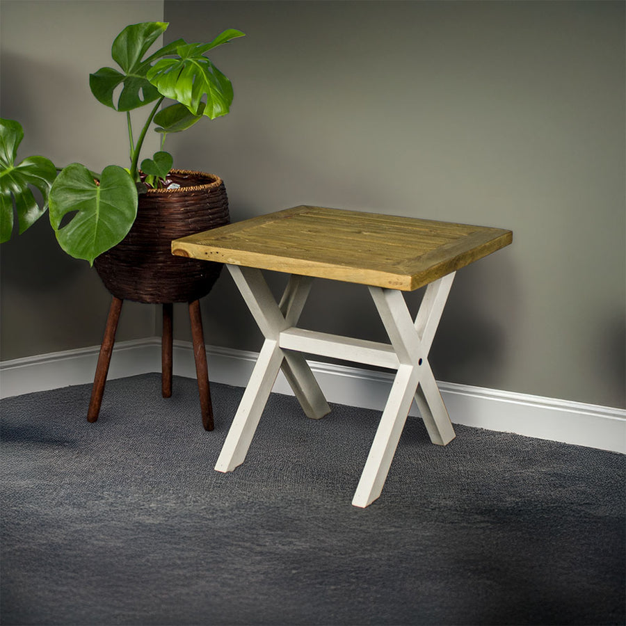 An overall view of the Byron Recycled Pine Lamp Table. There is a free standing potted plant next to it.