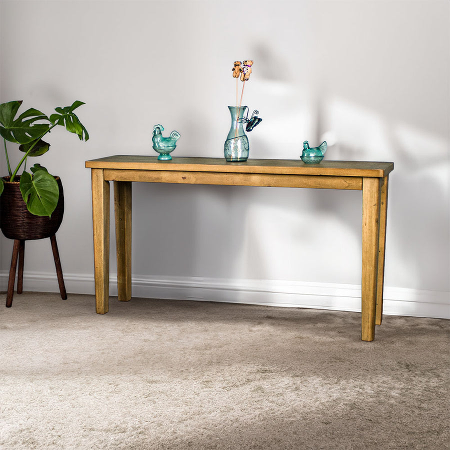 Front of the Cairns Recycled Pine Hall Table. There are two blue glass ornaments and a blue glass vase on top.