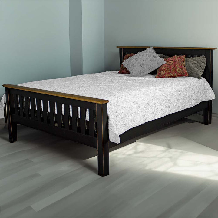 The front of the Cascais Oak Top Double Bed Frame in a modern bedroom, covered in sheets and pillows.