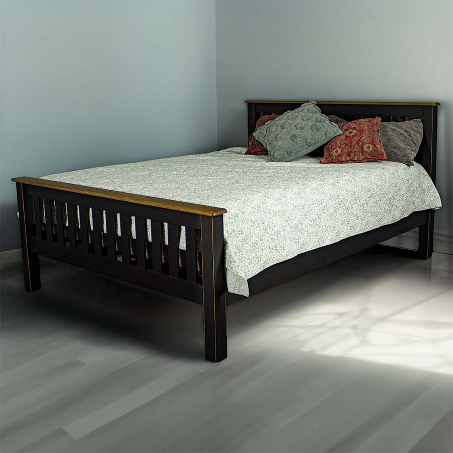 The front of the Cascais Oak Top Double Bed Frame in a modern bedroom, covered in sheets and pillows.