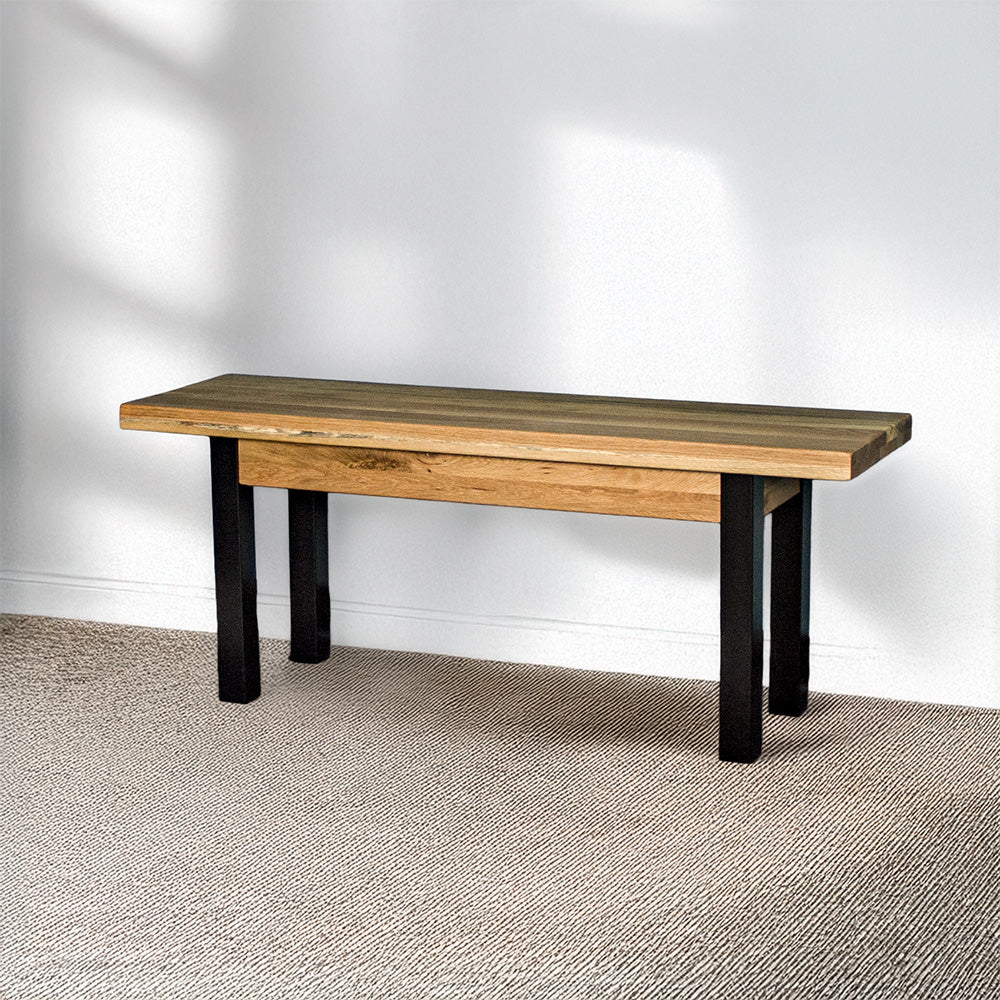 The front of the Golden Gate Oak Bench Seat. There is a beige rug in front.
