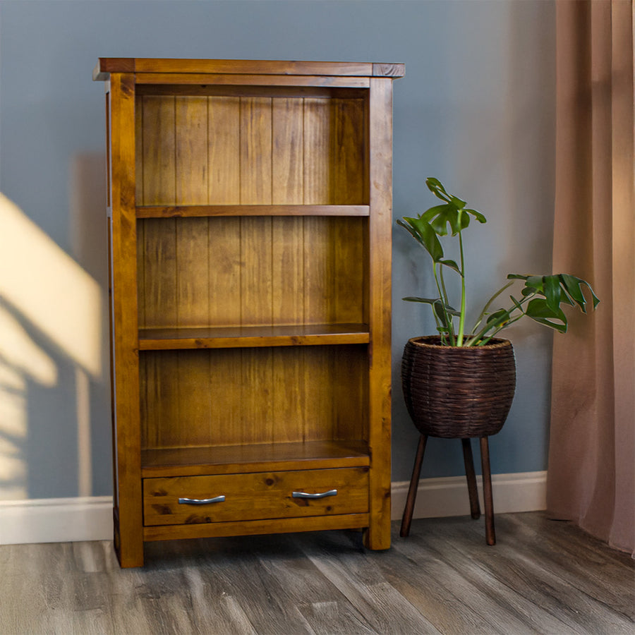 The front of the Monaco Bookcase. There is a free standing potted plant next to it.