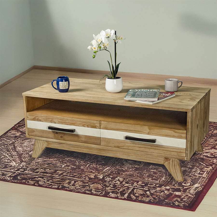 The front of the Soho 4 Drawer NZ Pine Coffee Table. There are two coffee mugs, two magazines and a pot of white flowers on top.