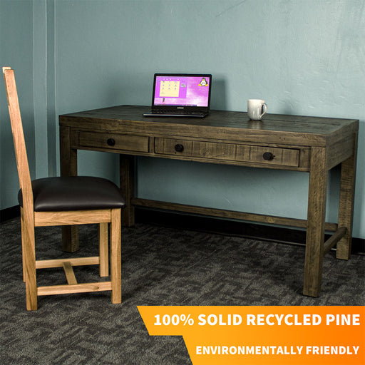Front of the Stonemill Recycled Pine Desk. There is an oak leather chair in front and a laptop and coffee mug on top.
