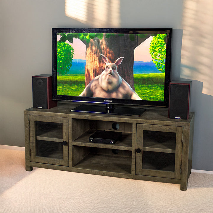 The front of the Stonemill Recycled Pine TV Unit with a TV and two speakers on top. There is a DVD player in the top shelf in the middle.
