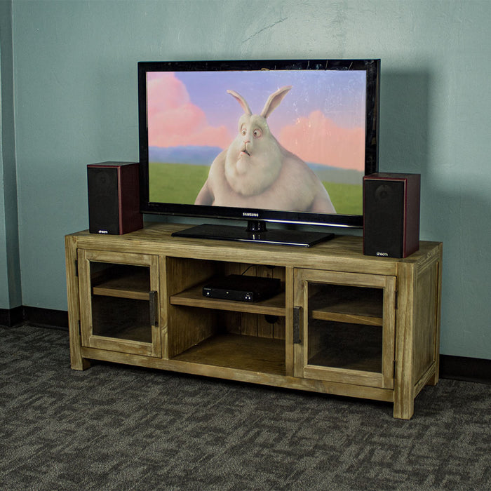 The front of the Vancouver 2 Door Entertainment Unit / TV Unit. There is a large TV on top with two speakers on either side. There is a DVD player on the top shelf in the middle of the unit.