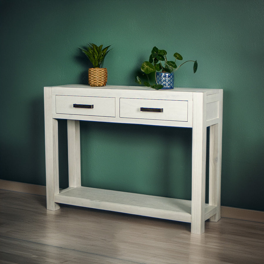 Vancouver 2 Drawer White Pine Hall Table front view. There are two potted plants on top.