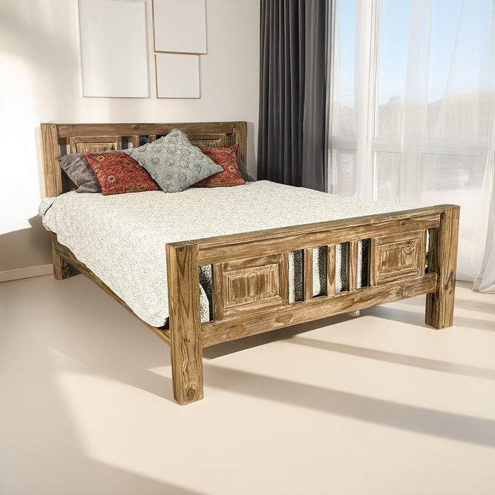 The front of the Vancouver Queen Size NZ Pine Slat Bed Frame, covered in blankets and pillows.