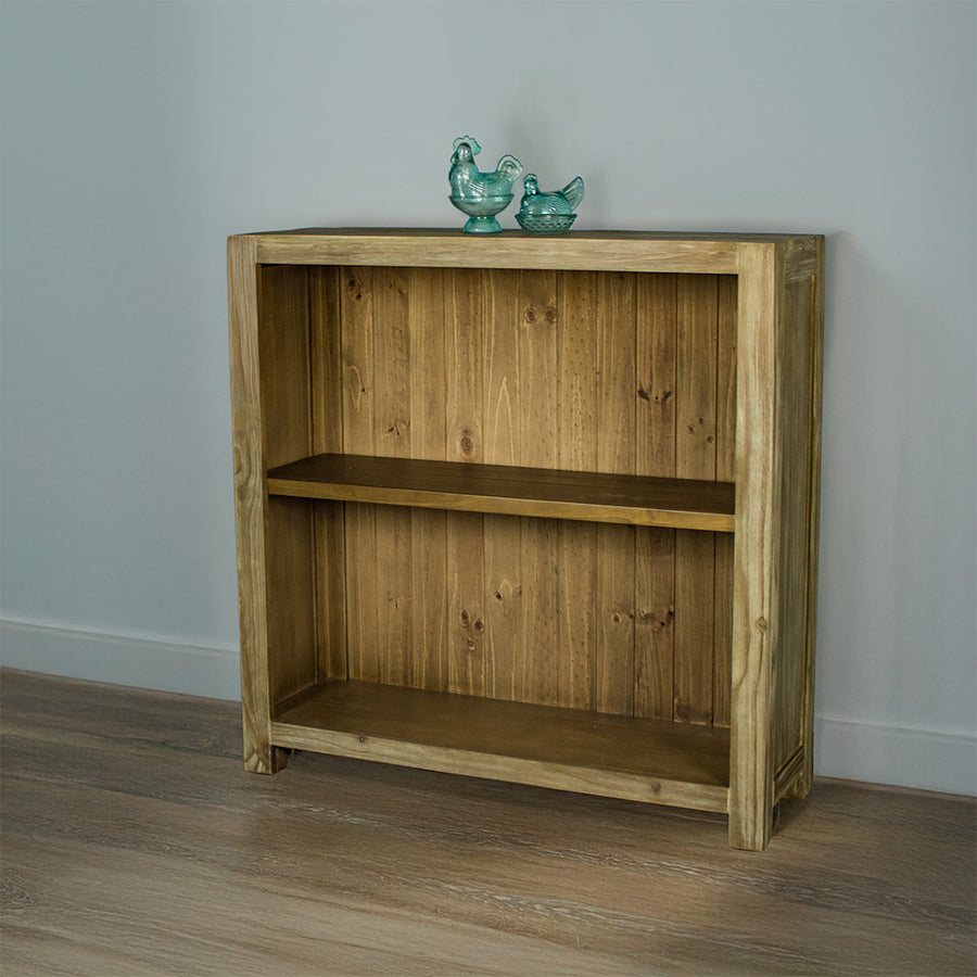 The front of the Vancouver Short Bookcase. There are two blue glass ornaments on top.