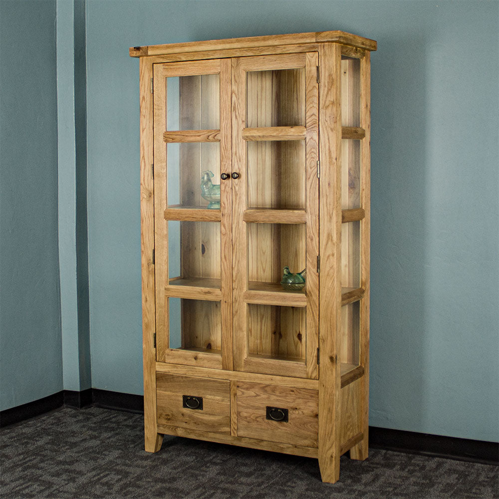 The front of the Vienna Oak Glass Display Cabinet. There are two blue glass ornaments in the windows of the two middle shelves.