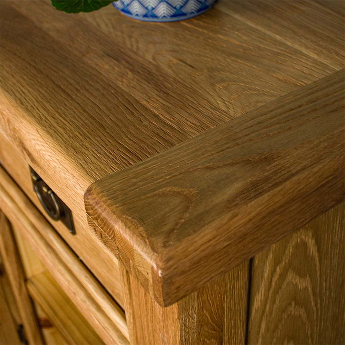 A close up of the top of the Yes 3 Door 3 Drawer Oak Buffet, showing the wood grain and colour.