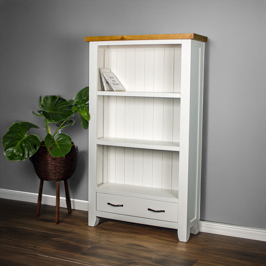 The front of the Felixstowe Pine Bookcase with a potted plant next to it.