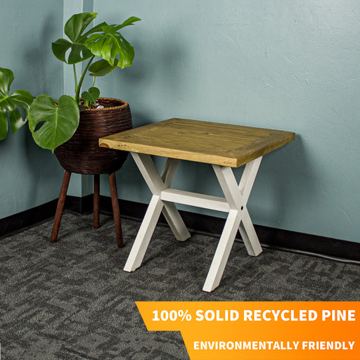 An overall view of the Byron Recycled Pine Lamp Table. There is a free standing potted plant next to it.