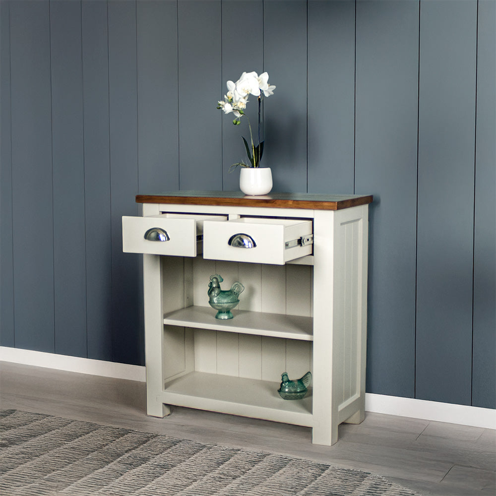 Front view of the Alton Hall Table with 2 Drawers, with its drawers open. There is a flower pot on top and two blue glass ornaments on the shelves.