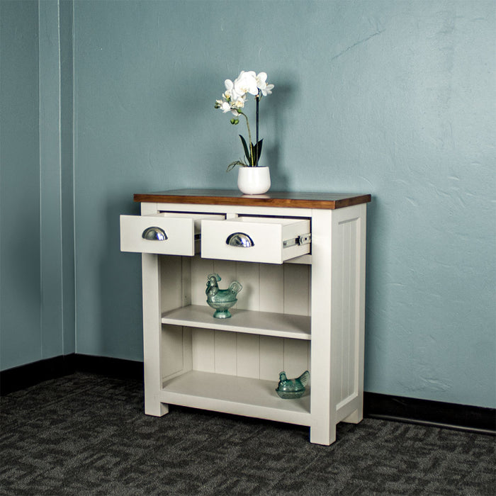 Front view of the Alton Hall Table with 2 Drawers, with its drawers open. There is a flower pot on top and two blue glass ornaments on the shelves.